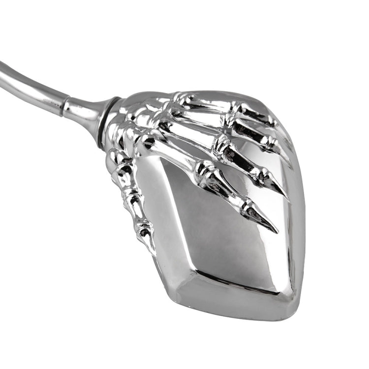 Chrome skeleton hand motorcycle rearview mirror close-up with reflective mirror face