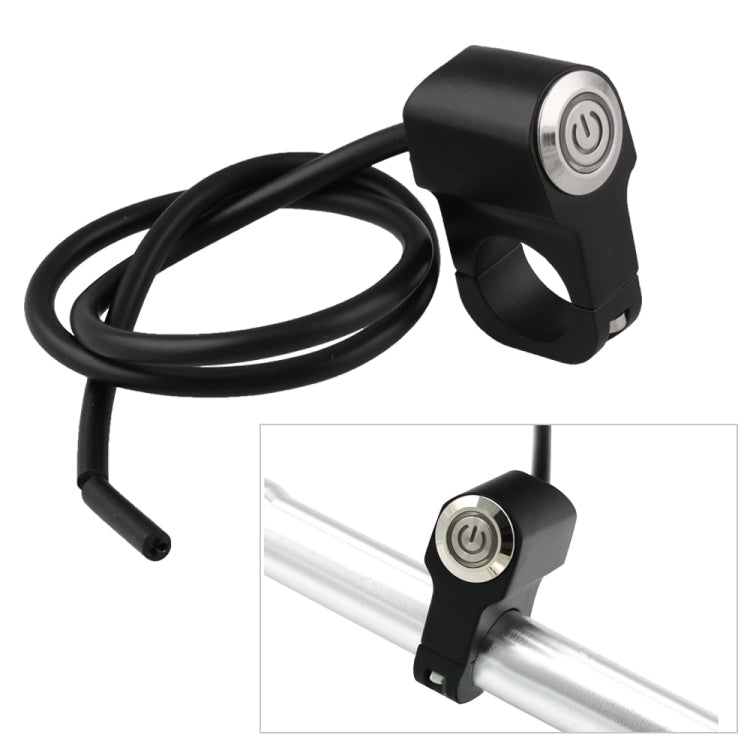 Black power switch with circular silver button and clamp mount for handlebar wiring