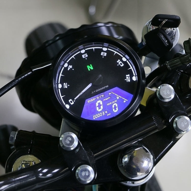 Mounted retro motorcycle LCD odometer on handlebars with blue-lit screen