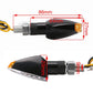 Triangular LED turn signal light with black housing, amber lens; 86mm long, 21mm high