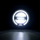 Round motorcycle LED headlight emitting bright white light, clear lens and black rim