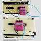 Multi-color effect cable connections on a pedalboard, with silver plug tips