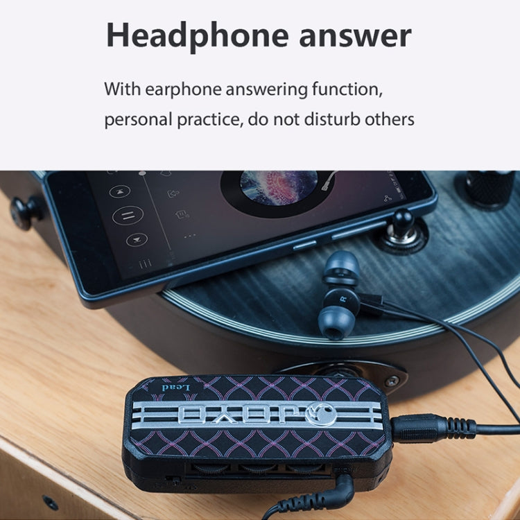 Portable mini guitar effects pedal connected by cable with earphone output.
