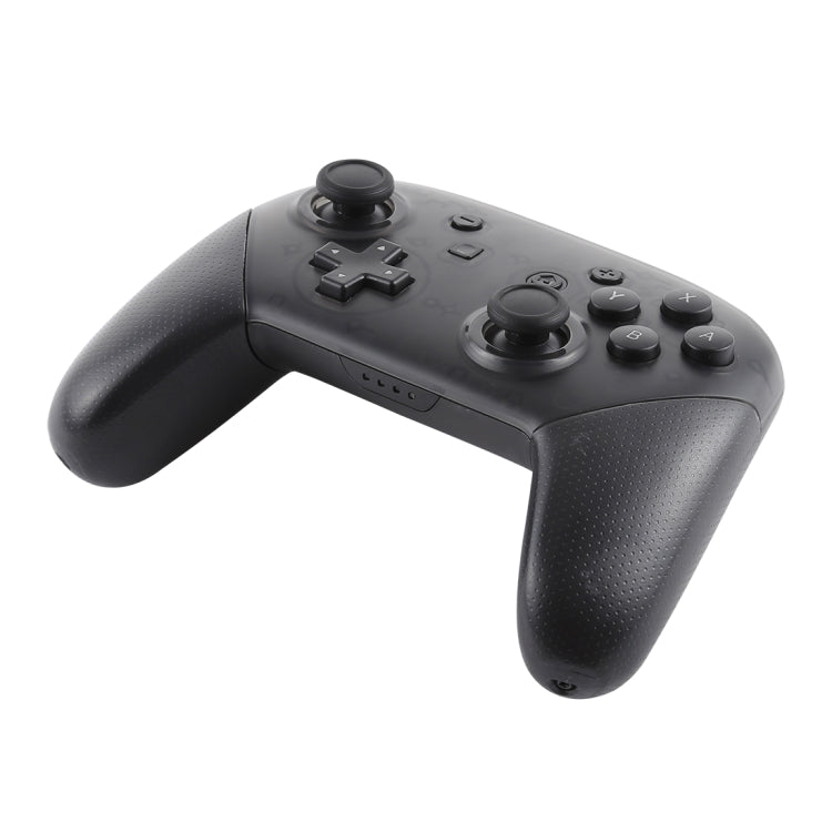 Black wireless game controller angled view with textured grips, D-pad, and thumbsticks