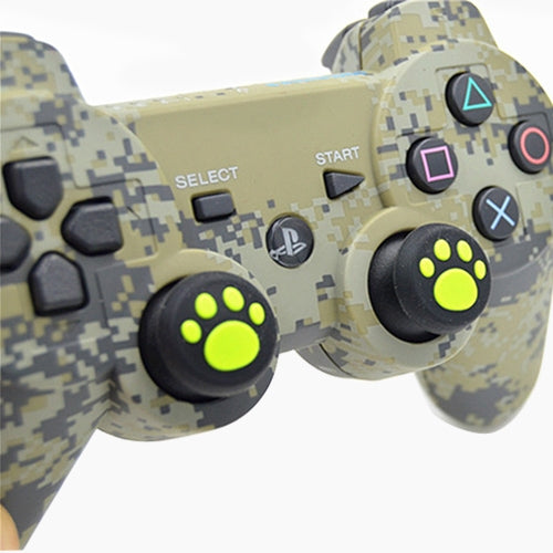 Cat-paw silicone joystick covers on a game controller, black with neon green print