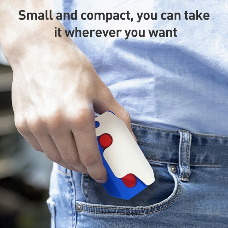 Pocket-knife fidget toy clipped in blue jeans pocket, showing red and white handle pieces
