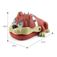 Dog-shaped bite toy angled view with cream jaw, white teeth, and green paw feet.