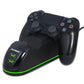 Black game controller on dual charging dock with green LED strip