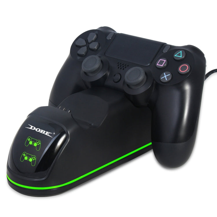 Black game controller on dual charging dock with green LED strip