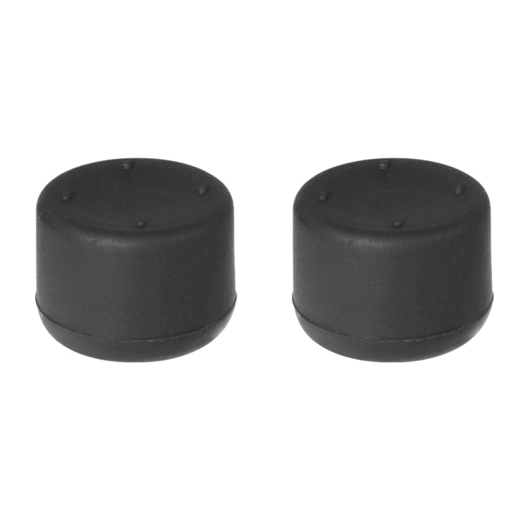 Two black dome thumb caps with textured top, analog cap kit