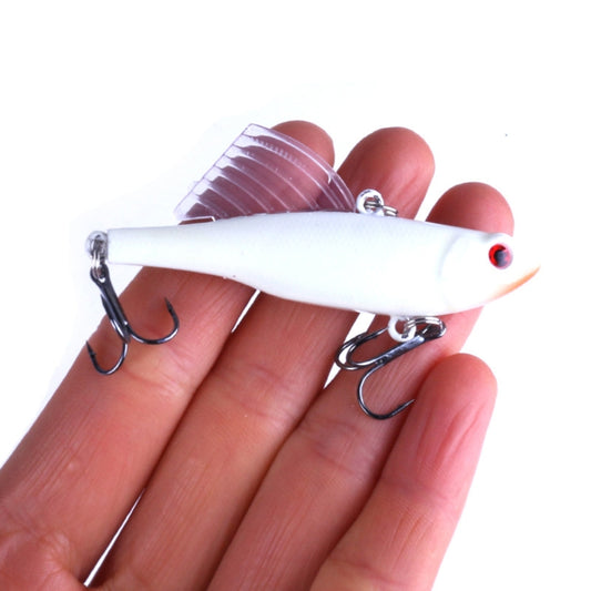 White winged pencil fishing lure held in hand, red eye, treble hooks