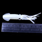 Luminous white squid soft bait lure with tentacle arms beside a measuring ruler