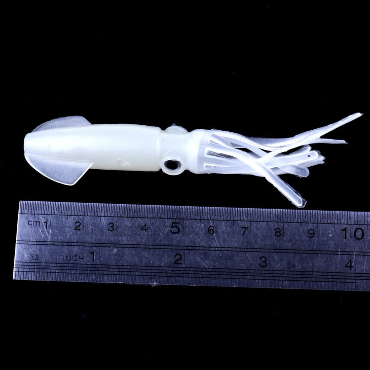 Luminous white squid soft bait lure with tentacle arms beside a measuring ruler