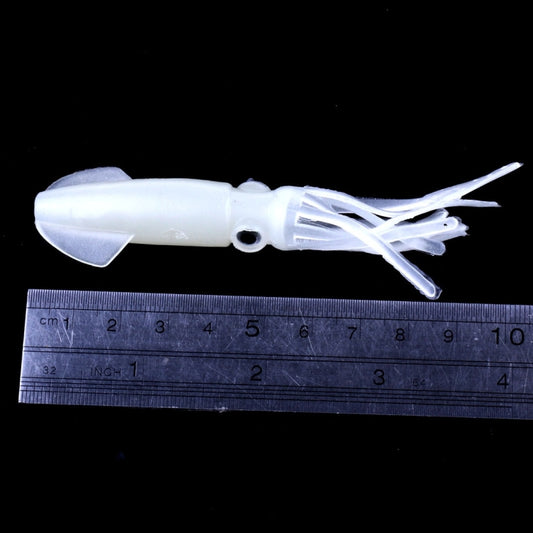 Luminous white squid soft bait lure with tentacle arms beside a measuring ruler