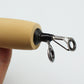 Close-up of ice fishing rod end plug with two metal line guide loops