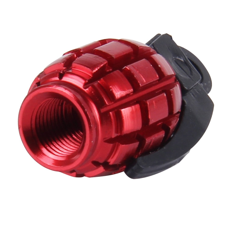 Red grenade-style tire valve cap with black base and threaded metal opening