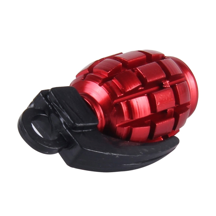Red grenade-style tire valve cap with black outer cover and threaded metal inlet