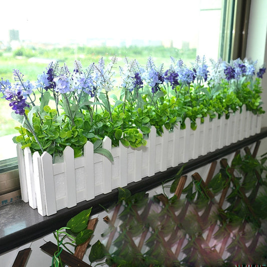 White picket-fence planter holder with foam base, green leaves and purple flowers
