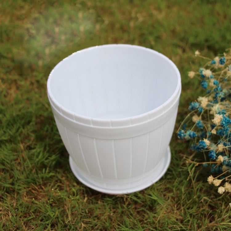 White plastic barrel-style flower pot with ribbed sides and round rim