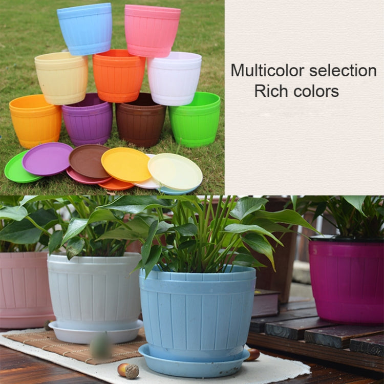 Assorted plastic flower pots with trays in white, orange, green, pink, purple, blue