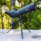 Blue-gray monocular telescope on tripod, side view with adjustment knobs.
