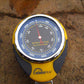 Yellow and black altimeter/barometer instrument with analog gauge and red pointer.