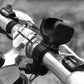 Black bike flashlight mounted on handlebars with protective cradle cover