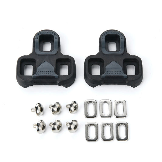 Pair of black road bike pedal cleats with mounting screws and metal plates