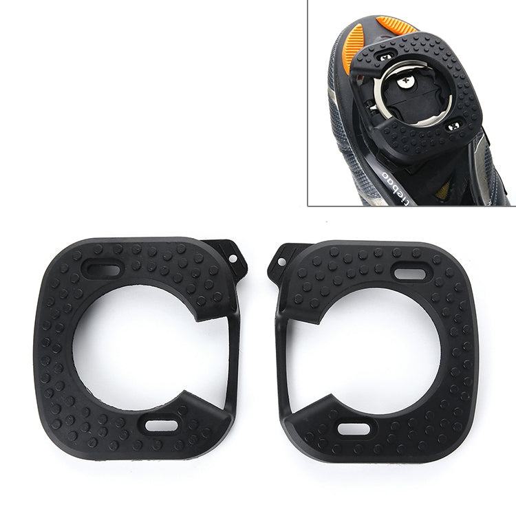 Black cycling cleat cover with textured grip and orange accents, protective shell