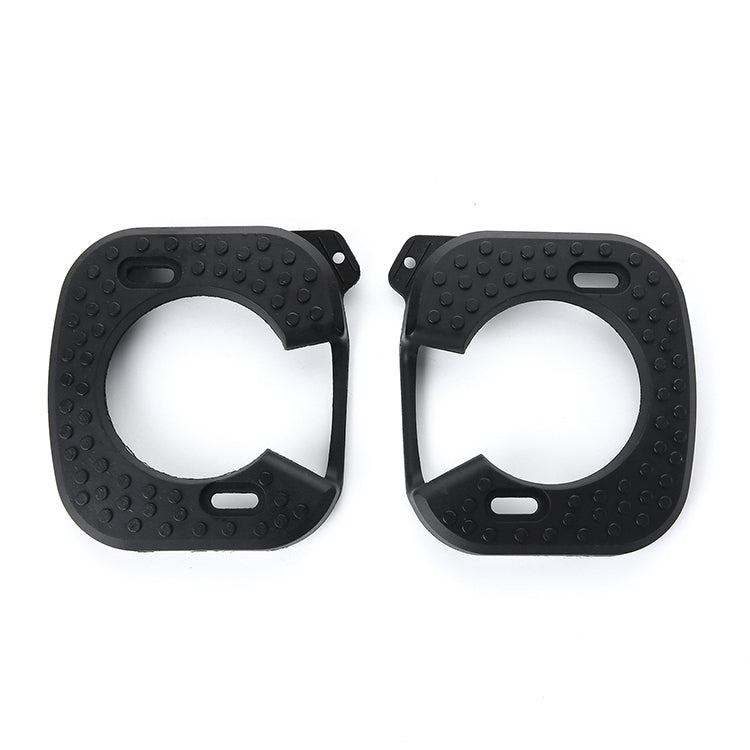 Pair of black textured cycling cleat covers with small mounting tabs