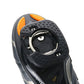 Close-up of black cleat cover with circular opening and orange backing tab