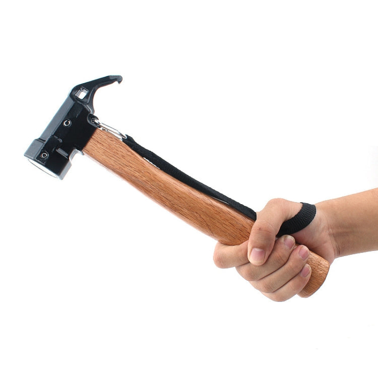 Shark-style nail puller hammer with black head and wooden handle, gripped by hand