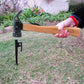 Shark-style nail puller hammer with black head and wooden handle in outdoor use