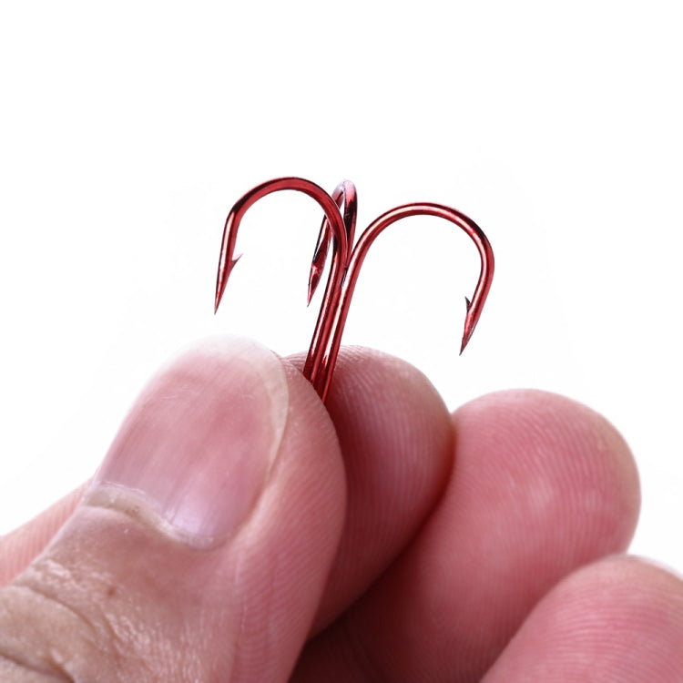 HENGJIA red treble fishing hook held between fingers, showing three barbed points