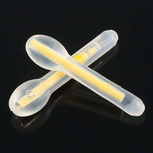 Crossed bulb-shaped luminous fishing light sticks, clear holders glowing pale yellow