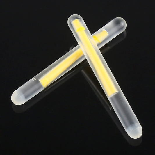 Crossed fishing light sticks with bright yellow glow in clear tubes
