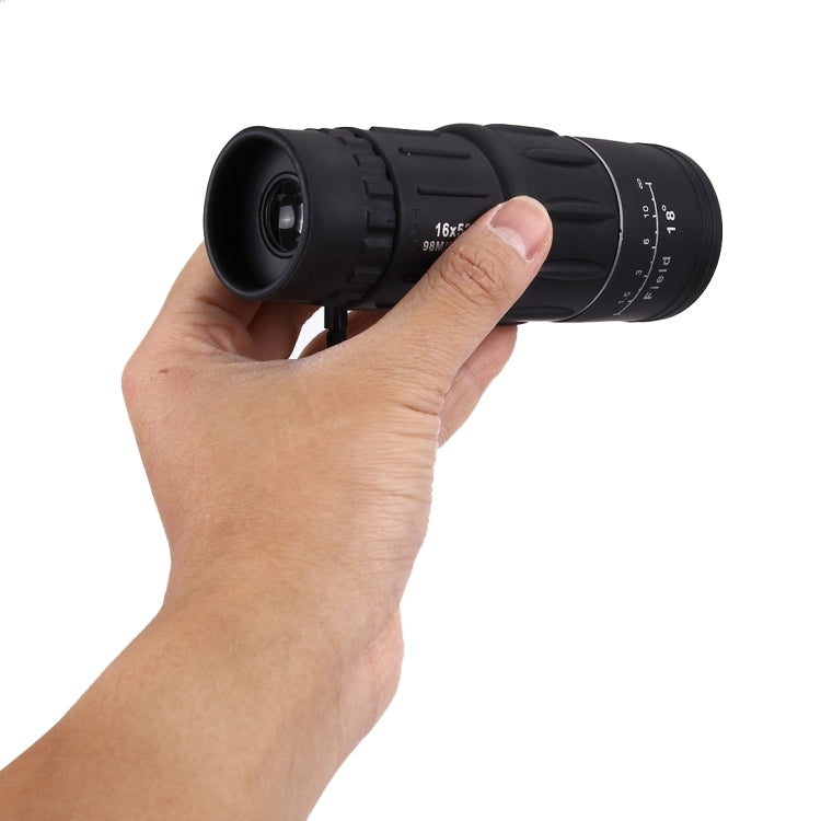 Black monocular telescope held in hand, showing eyepiece and focus ring