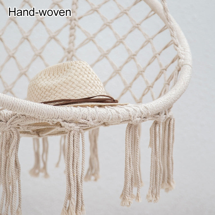 Beige hand-woven rope hanging swing chair with round net seat and fringed edges