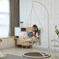 Beige rope hanging swing chair with oval net seat and fringed hammock-style cushion