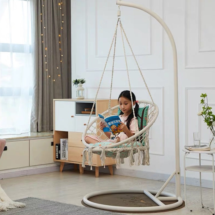 Beige rope hanging swing chair with oval net seat and fringed hammock-style cushion