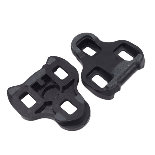 Pair of black road bike pedal cleats with four cutouts and raised center mount