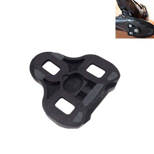 Black road bike cleat with four rectangular traction openings and center mounting plate