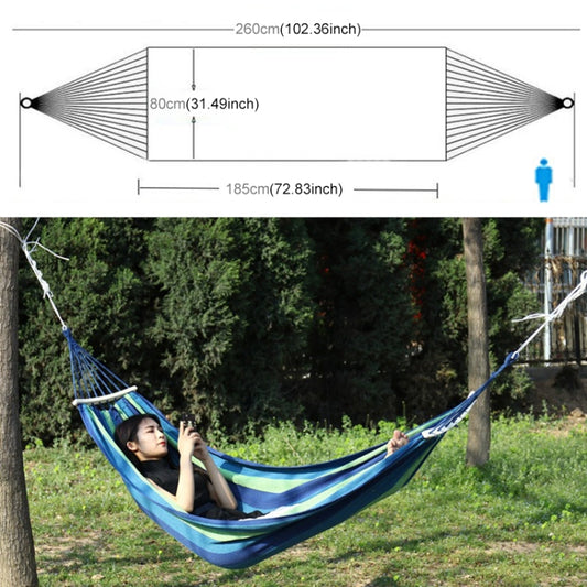 Portable single-person canvas hammock, blue and green striped fabric suspended between trees