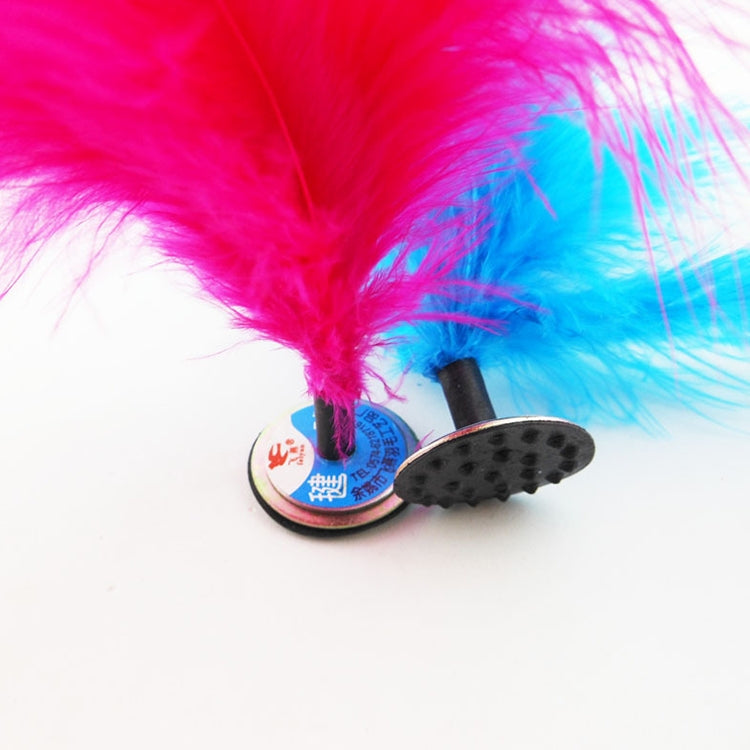 Close-up of pink feather kick shuttlecock on round base with black grip treads
