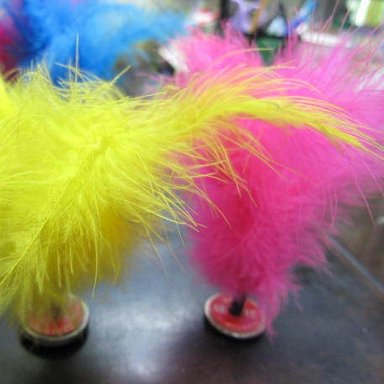 Yellow and pink feather kick shuttlecock with long plumes on a round base