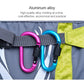 Two D-ring buckle locks clipped to a webbing strap on outdoor gear, multicolor