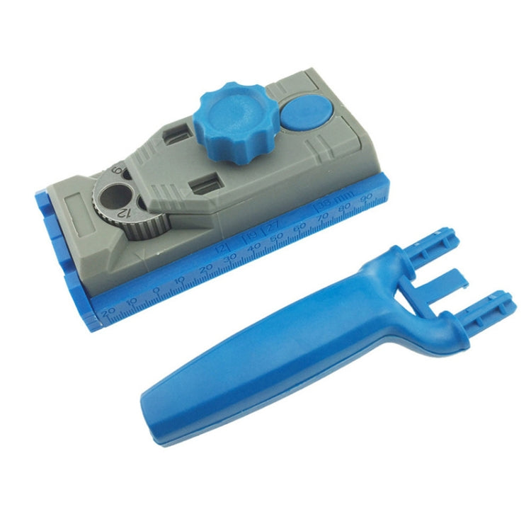 Woodworking borehole locator with blue-and-gray base, built-in scale, and blue clamping handle