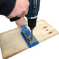 Woodworking borehole locator jig on wood with mounted drill bit