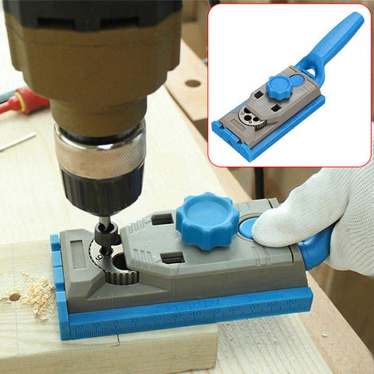 Borehole locator jig in use with drill bit and blue adjusting knob on wood