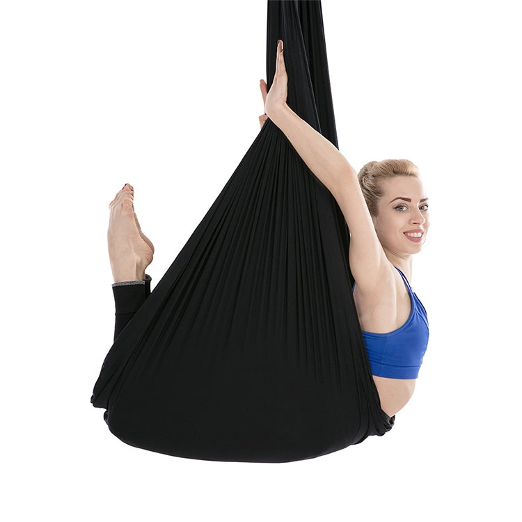 Black aerial yoga hammock with support ropes and gathered fabric seat